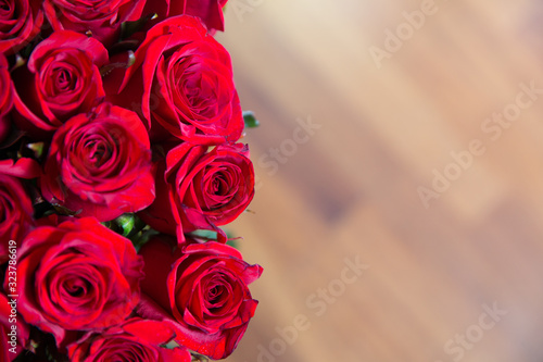 Rose blurred background. Roses flower texture. Red rose. Bouquet of red roses. copyspace . The letter A is written with white flowers . Beautiful rose flower in garden.