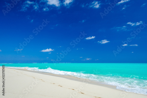 Photography Tropical white sand beach, turquoise water and blue sky.