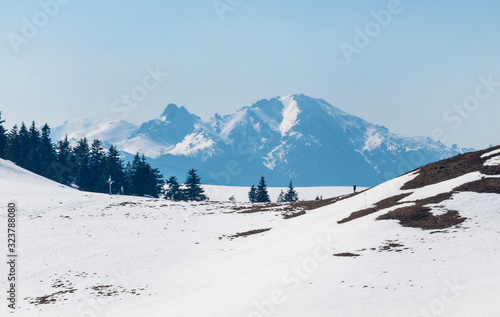 Snow covered mountain range in spring on a clear day