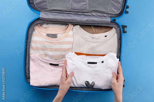 Woman packing travel suitcase