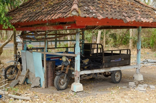 Parked motorbike designed to carry more people on the island of Bali.