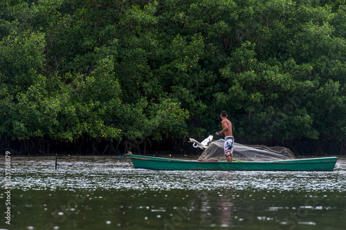 Fishing net and Great Egret photographed in Vitoria, Espirito Santo. Southeast of Brazil. Atlantic Forest Biome. Picture made in 2016.