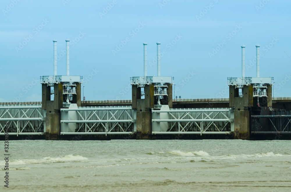 Oosterschelde, the Netherlands, August 2019. The large dam that protects the area from storms and floods is visible from the beach. Oosterschelde, the Netherlands, August 2019. The large dam that protects the area from storms and floods is visible from the beach.