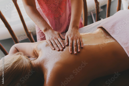 Woman receiving a back massage in a spa center.
