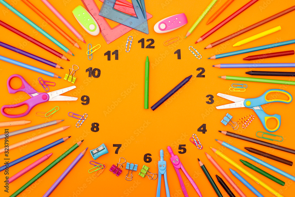 Fototapeta premium Creative clock made of school and office supplies with clock wise 