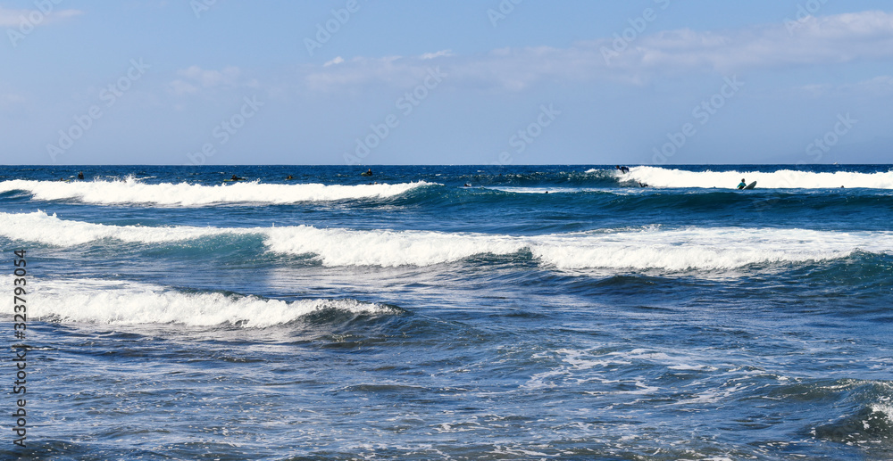 white waves on a blue beach with sky