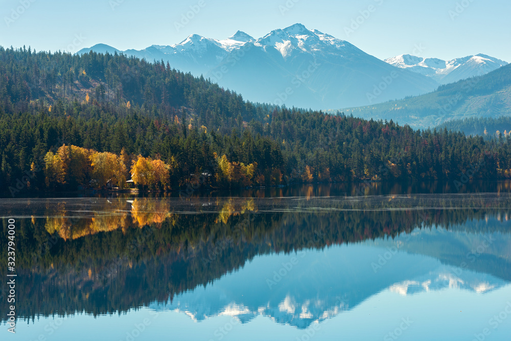 Snowy mountains reflected in Gun Lake in British Columbia, Canada