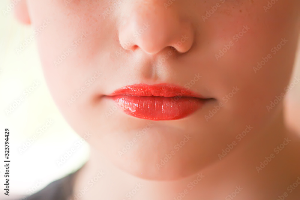 Young attractive teenager girl's face view with lipstick on lips Young attractive teenager girl's face view with lipstick on lips