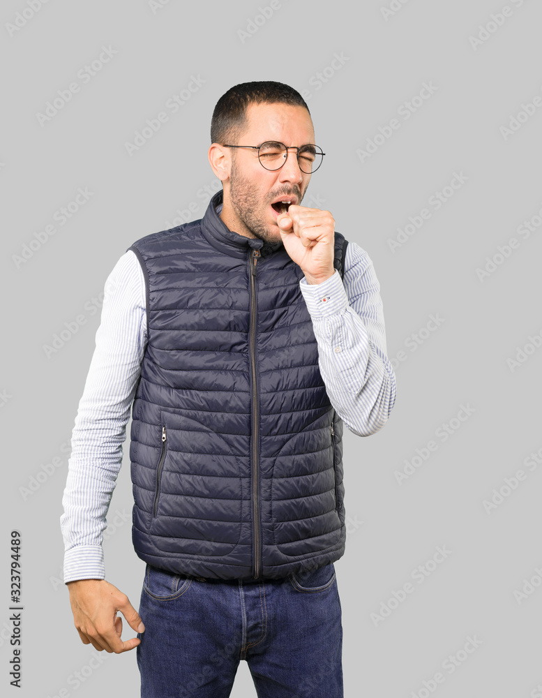 Sick young man coughing Sick young man coughing