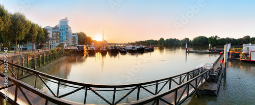 Panoramic view of Wandsworth Harbor illuminated at sunset and Thames river at twilight in Battersea area of London in UK