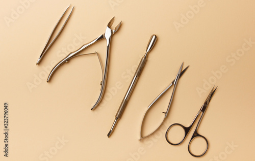 Professional manicure tools on beige background. Manicure set. Top view
