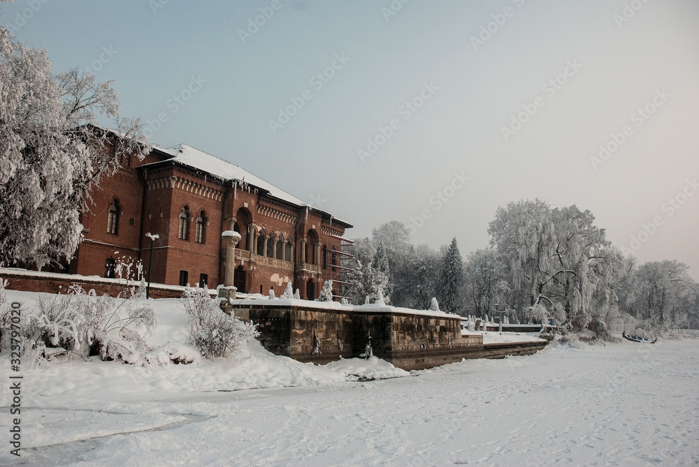 Mogosoaia castle brick traditional architecture during the winter seen from the frozen lake. Mogosoaia castle brick traditional architecture during the winter seen from the frozen lake.