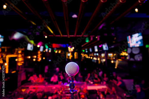 Fototapeta Comedy Microphone on Stage of Comedy Music Show in Club with Lights and Colors