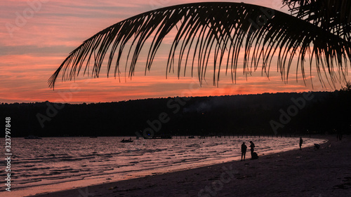 two Backpacker walking on the beach at sunset