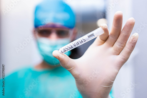 Scientist doctor holds test tube with Lassa fever photo