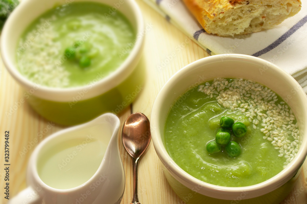 Vegetarian smoothie soup with green vegetables. Proper and healthy nutrition. Green puree soup with broccoli, zucchini, spinach, peas and vegetable milk. Vegan soup.