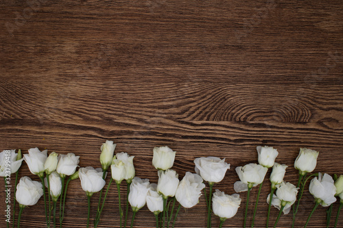 white lisianthus flowers on wooden background