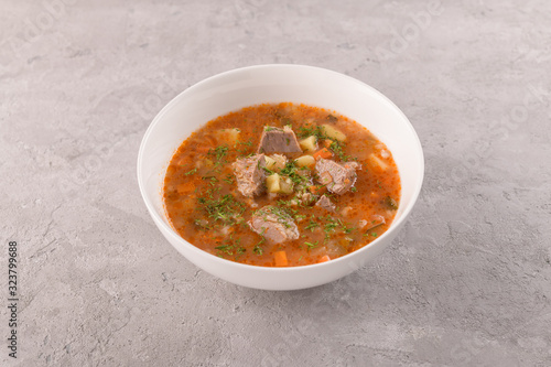 soup with beef in a white plate