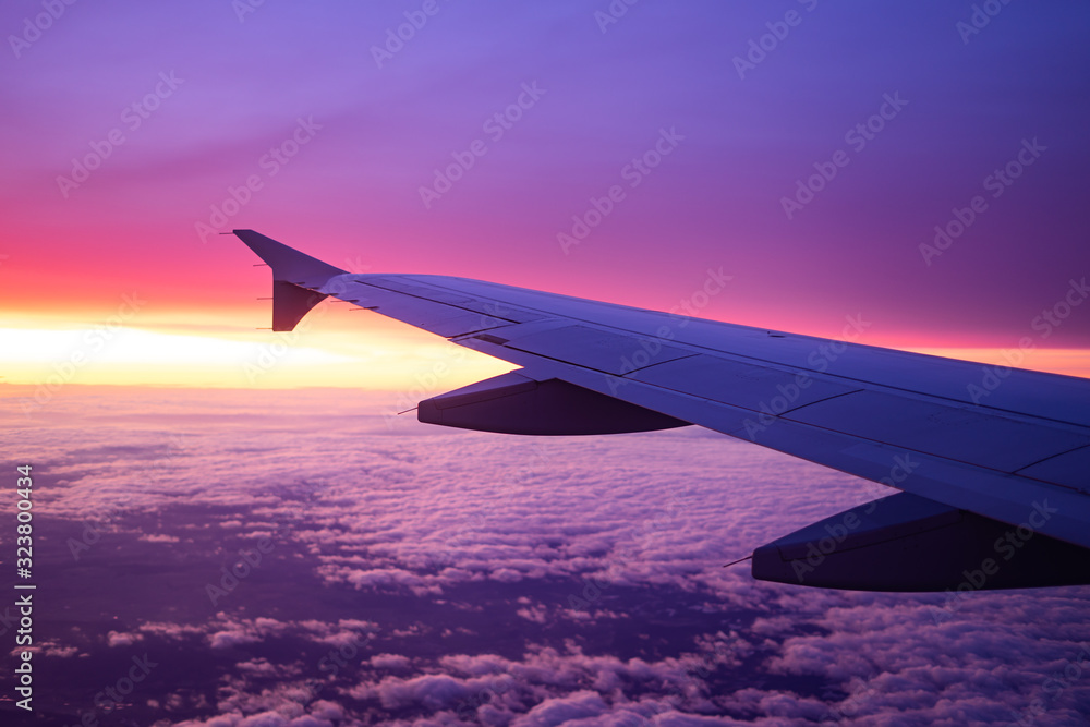 Fototapeta premium wing view plane in the sky sunrise
