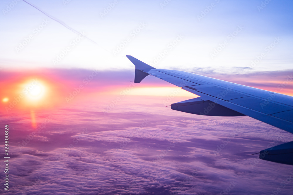 Obraz premium wing view plane in the sky sunrise