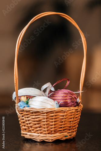 Easter basket with Easter eggs on a rustic plank with antique panel for background.