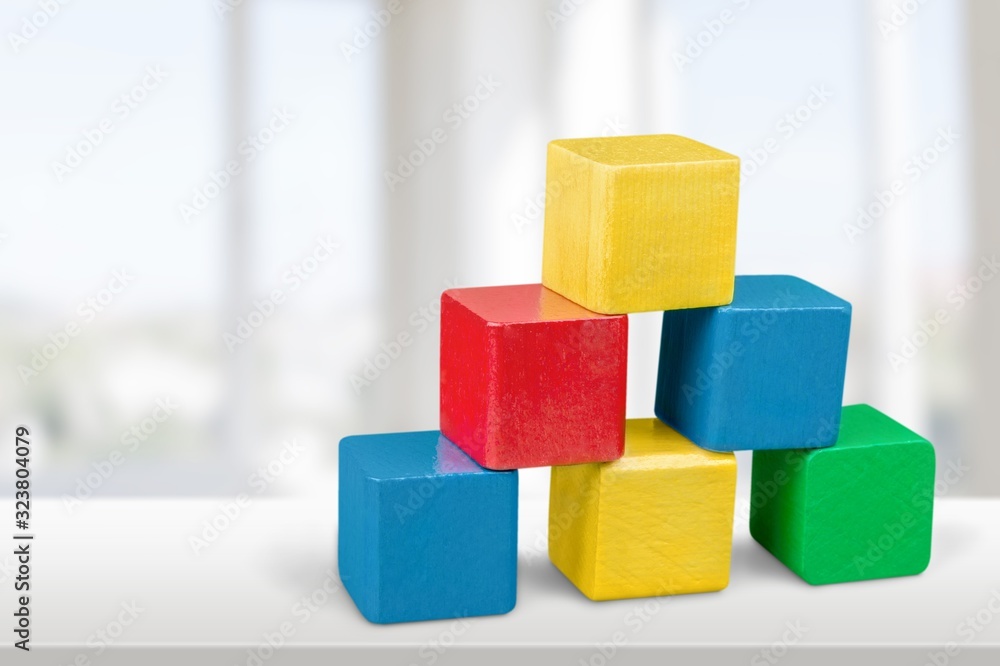 Wooden colored building cubes on the table Wooden colored building cubes on the table