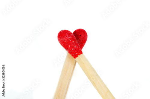 Fotografie matchstick with a red heart-shaped head on a white background