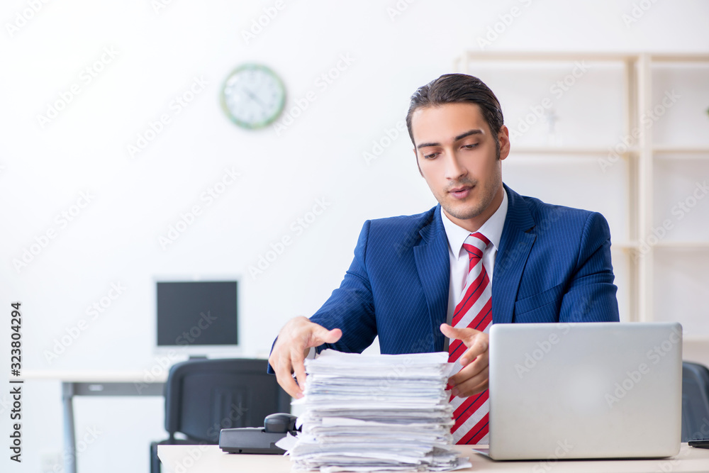 Young male businessman sitting in the office Young male businessman sitting in the office