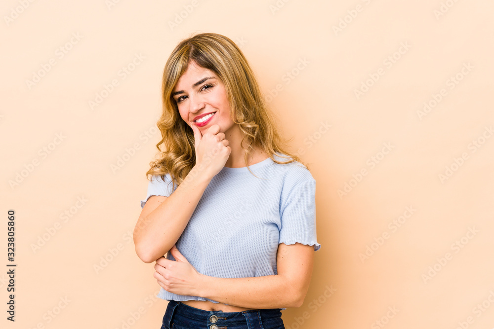 Young blonde caucasian woman smiling happy and confident, touching chin with hand. Young blonde caucasian woman smiling happy and confident, touching chin with hand.