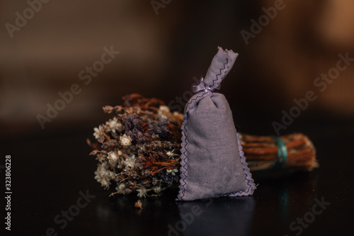 Dried lavender in a sack isolated on rustic background. Bouquet of lavender in sack on vintage background.