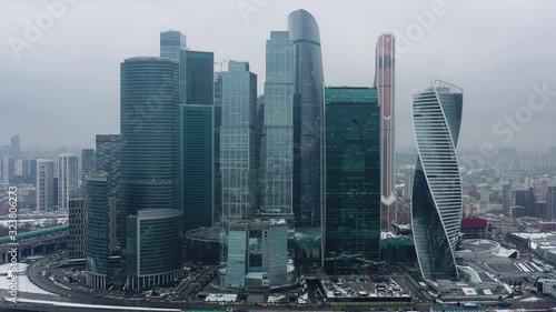 Aerial drone shot flying over center of Moscow city buildings, skyscrapers at cloudy winter day. Drone shot flying over Moscow skyscrapers. photo