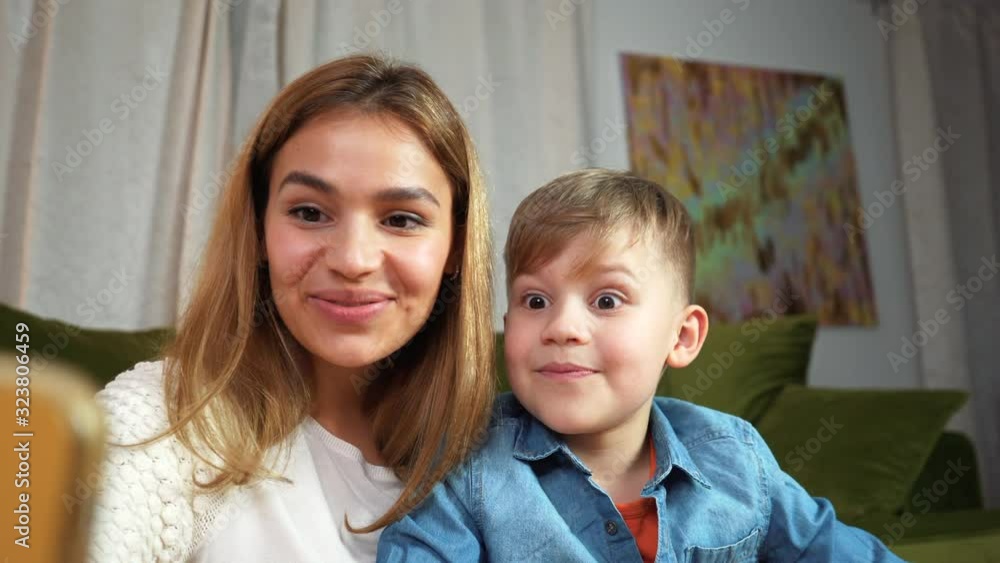 Beautiful mom and son making selfie at home. Happy family having a facetime video call. Unity, connection, technology concept Beautiful mom and son making selfie at home. Happy family having a facetime video call. Unity, connection, technology concept
