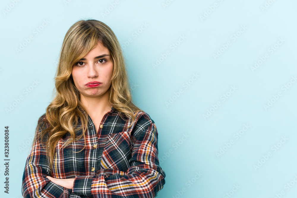 Young blonde caucasian woman blows cheeks, has tired expression. Facial expression concept. Young blonde caucasian woman blows cheeks, has tired expression. Facial expression concept.