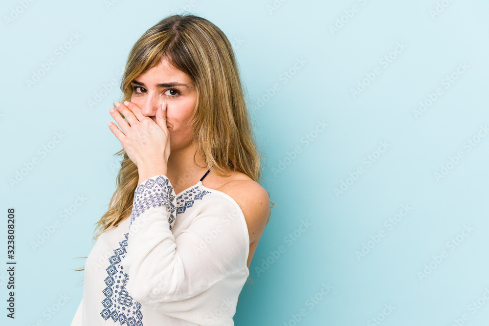 Young blonde caucasian woman covering mouth with hands looking worried. Young blonde caucasian woman covering mouth with hands looking worried.