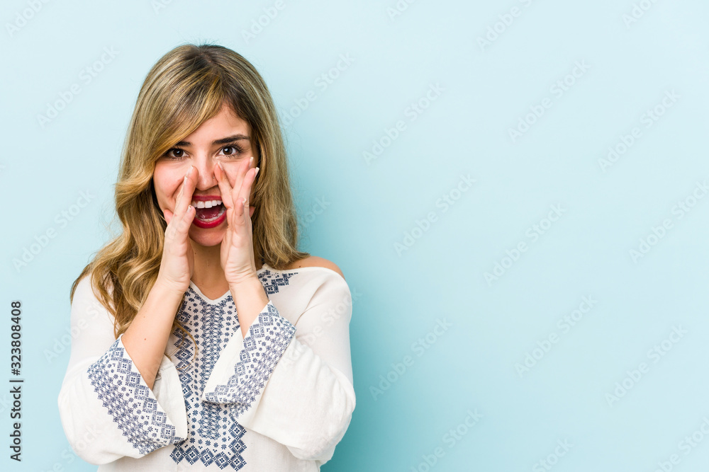 Young blonde caucasian woman saying a gossip, pointing to side reporting something. Young blonde caucasian woman saying a gossip, pointing to side reporting something.