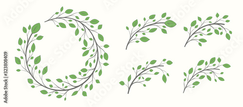 Frame of a branch with green leaves in the shape of a circle plus a set of branches with leaves