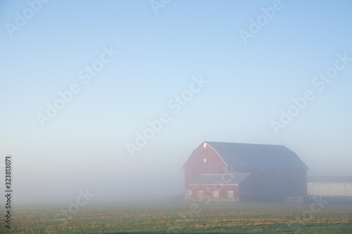 Farm barn in foggy morning © Elton