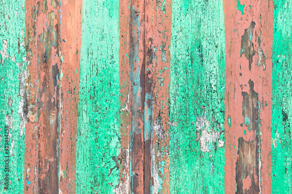 Wooden shabby fence painted in light green and lines beige color. Texture, background