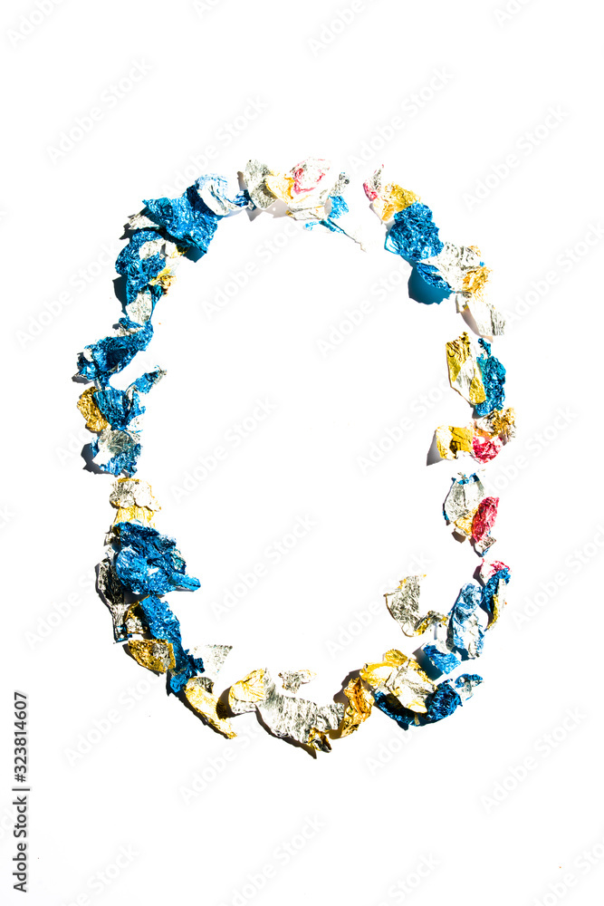 Letter smade with broken piece of chocolate wrapping papers, , typography concept for easter, , see the rest of the serie Letter smade with broken piece of chocolate wrapping papers, , typography concept for easter, , see the rest of the serie