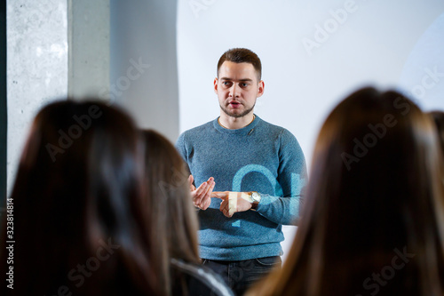 guy businessman at the conference tells information to people