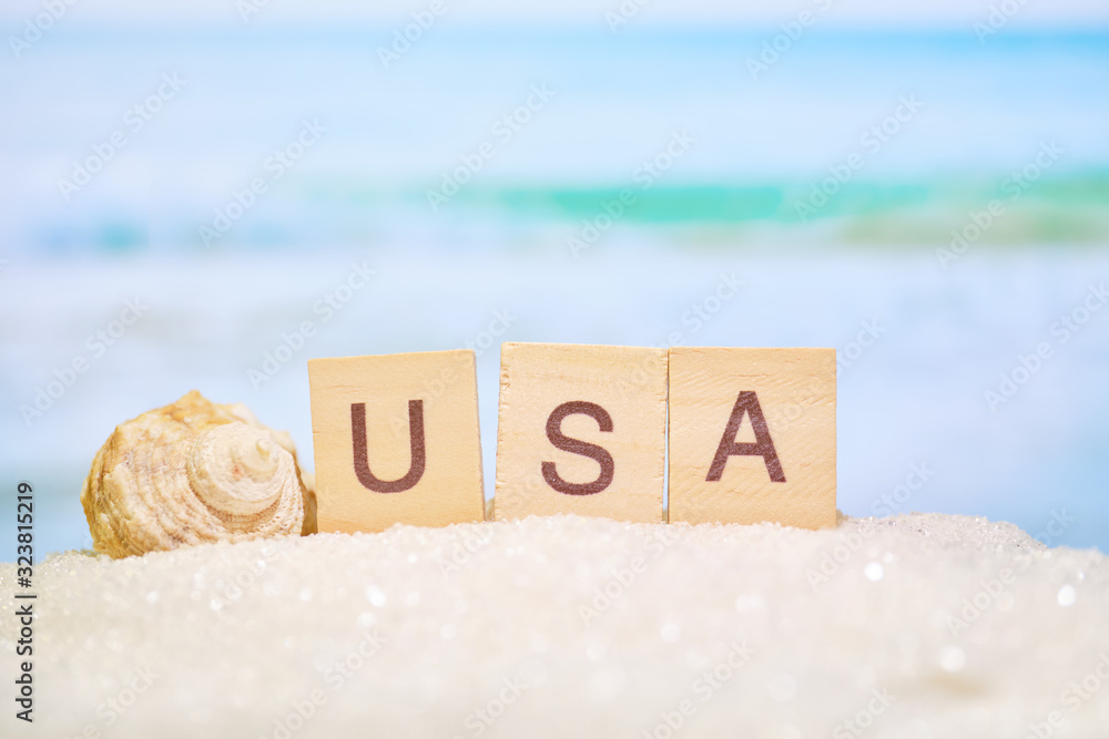 Beautiful blurred view of the beach and with the letters with the word. America as one of the popular resorts for tourism and recreation.