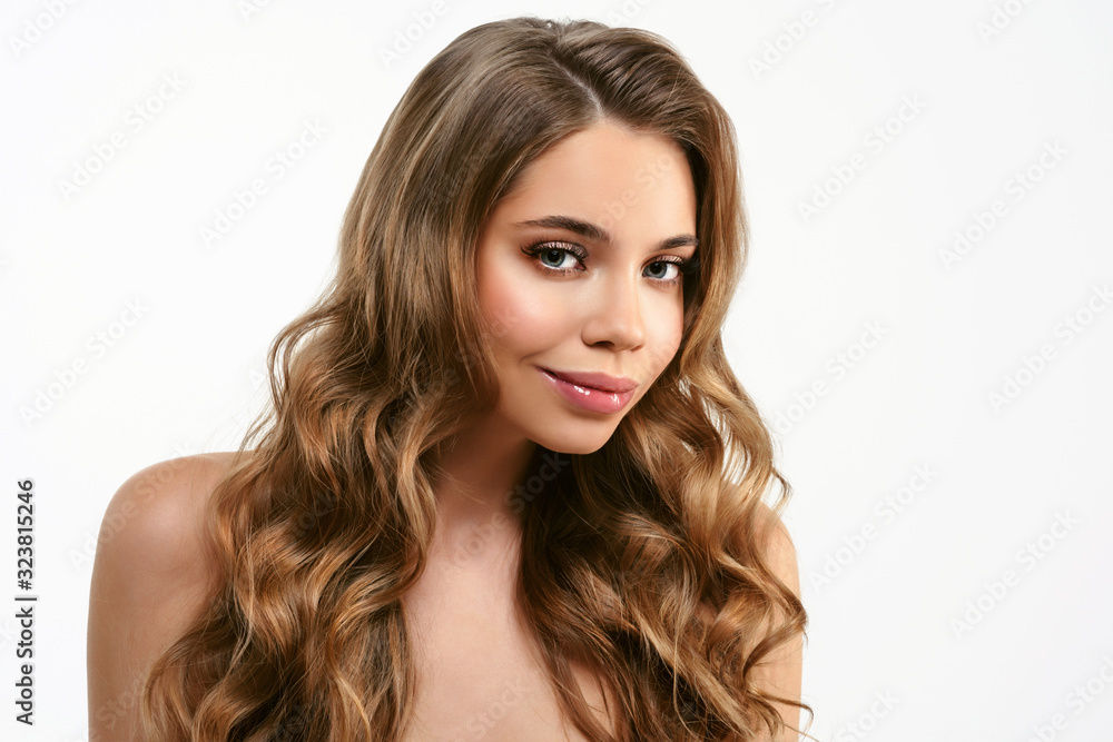 Portrait of young beautiful woman isolated at white background. Blonde girl with long and shiny wavy hair . Smiling friendly girl with curly hairstyle Portrait of young beautiful woman isolated at white background. Blonde girl with long and shiny wavy hair . Smiling friendly girl with curly hairstyle