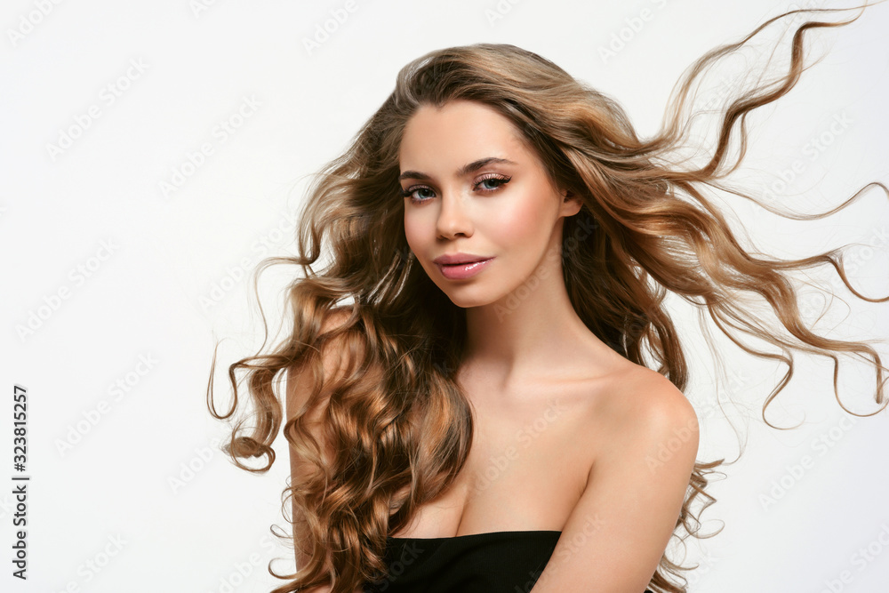Portrait of young beautiful woman isolated at white background. Blonde girl with long and shiny wavy hair . Smiling friendly girl with curly hairstyle Portrait of young beautiful woman isolated at white background. Blonde girl with long and shiny wavy hair . Smiling friendly girl with curly hairstyle