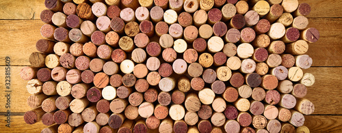 Very high resolution photo of standing red wines used corks arranged in rows and columns on wooden rustic background. All specific terms were removed.