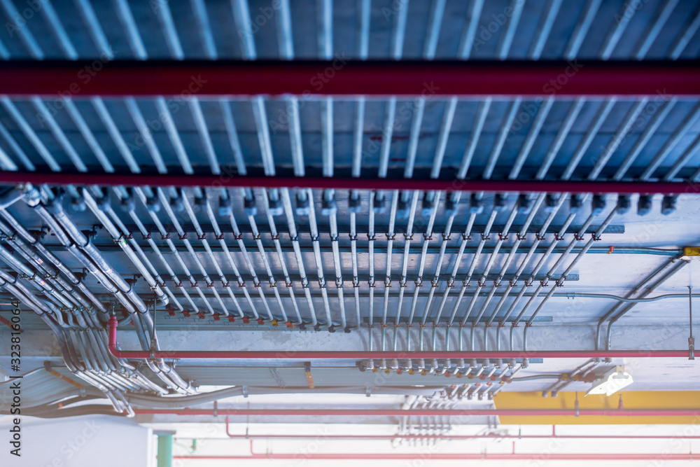 Blurry picture of electrical conduit and cabling. Blurry image for construction background. The rows of electrical conduit and signal cables in the parking building. Blurry picture of electrical conduit and cabling. Blurry image for construction background. The rows of electrical conduit and signal cables in the parking building.