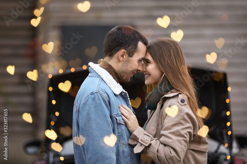 Happy young couple near car...