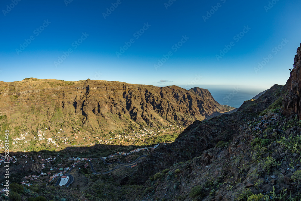 Parking at the observation point overlooking the gorge Valle gran Rey - Grate King Valley. Viewpoint and restaurant constructed by canarian architect Cesar Manrique. La Gomera, Canaryislands, Spain Parking at the observation point overlooking the gorge Valle gran Rey - Grate King Valley. Viewpoint and restaurant constructed by canarian architect Cesar Manrique. La Gomera, Canaryislands, Spain