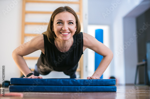 Fototapeta young woman training at the gym