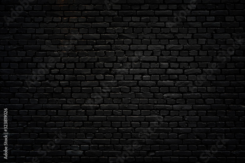 Black brick wall as background or wallpaper or texture photo