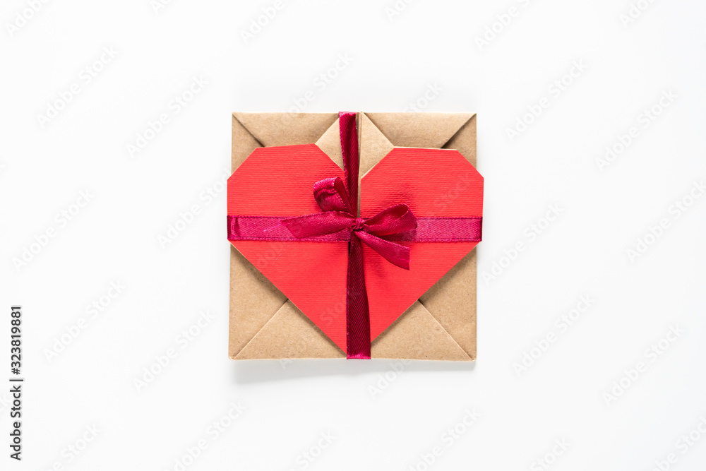 Hart shaped paper gift card tied with red ribbon on the white background top high angle view Hart shaped paper gift card tied with red ribbon on the white background top high angle view